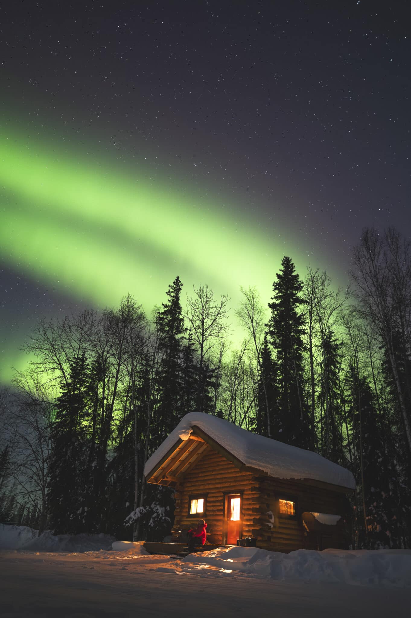 Wide-angle lens setup outside a snow covered cabin - wide angle lens auroras